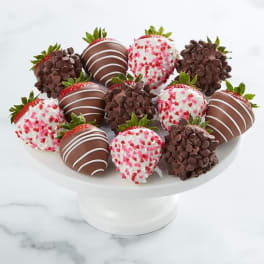 Plate of chocolate-covered strawberries with white and pink sprinkles