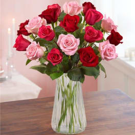 Bouquet of red and pink roses in a clear glass vase