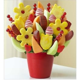 Fruit bouquet in a red pot with melon slices and berries