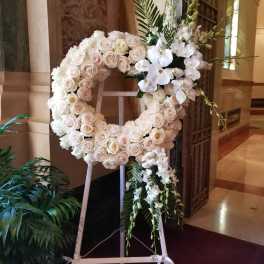 White rose and orchid wreath on a standing easel