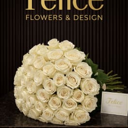 Large bouquet of cream roses with a small card