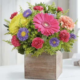 Colorful mixed flower arrangement in a wooden box
