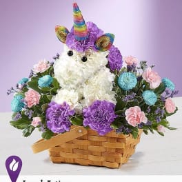 Unicorn-shaped floral arrangement in a basket with purple, pink, and blue flowers