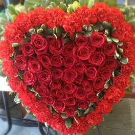 Heart-shaped bouquet of red roses and carnations