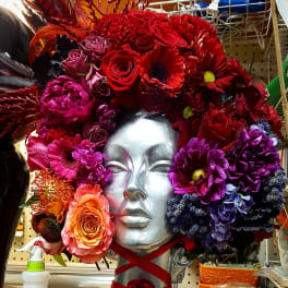 Colorful floral headpiece on a silver mannequin bust