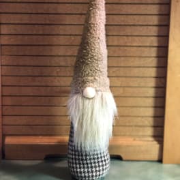 Tall decorative gnome figurine with a long white beard and pointed hat