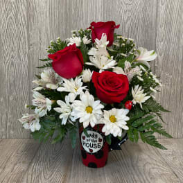 Red roses and white daisies in a red ladybug vase