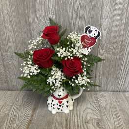Red roses in a Dalmatian-shaped mug with a heart pick