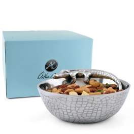 Decorative bowl of mixed nuts with a silver crocodile handle and blue box