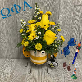 Yellow roses and daisies in a striped bee pot with sports-themed accessories