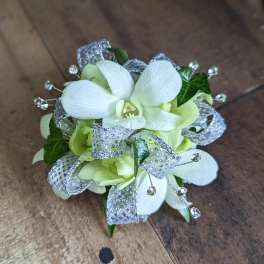 White orchid corsage with silver ribbon and crystal accents