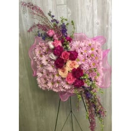 Pink and purple floral standing spray on an easel