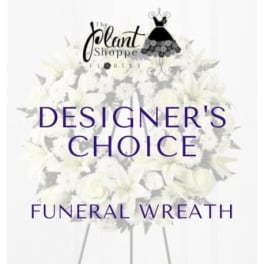 White funeral wreath on a stand with purple text overlay.