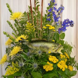 Floral arrangement with a fish centerpiece in yellow, blue, and green