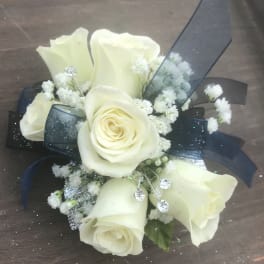 White roses with baby's breath and dark ribbon accents
