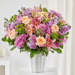 Pink and peach bouquet in a white vase
