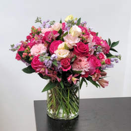 Pink and cream mixed bouquet in a clear glass vase