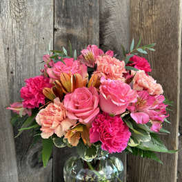 Pink roses and carnations in a glass vase