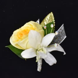 Yellow rose and white orchid boutonniere with glittery ribbon accents
