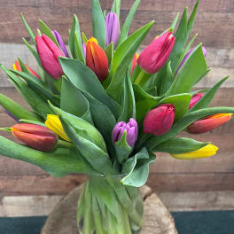 Colorful tulip bouquet in a clear glass vase