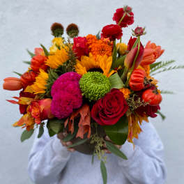 Bright mixed bouquet with sunflowers, roses, and orange blooms