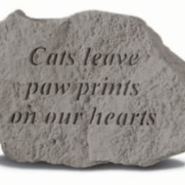 Engraved stone with the words "Cats leave paw prints on our hearts"
