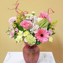 Pink and white mixed bouquet in a mauve vase