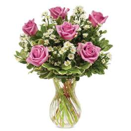Pink roses and white daisies in a clear glass vase