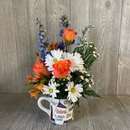 Mixed bouquet in a white mug with orange and white flowers