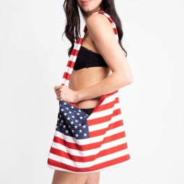 Patriotic shoulder bag with American flag design worn by a woman in a black bikini
