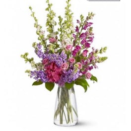 Mixed pink and purple flowers in a clear glass vase