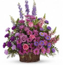 Basket arrangement of pink and purple flowers with tall lavender spikes
