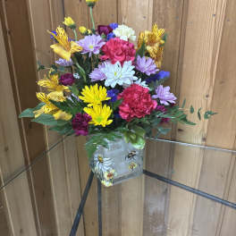 Colorful bouquet in a decorated square glass vase