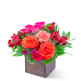 Mixed pink and orange flowers in a wooden box