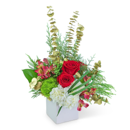 Red roses and white hydrangeas in a white box with mixed greenery