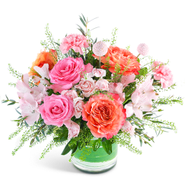 Pink and coral mixed bouquet in a glass vase