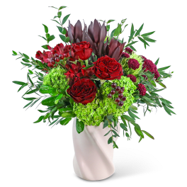 Red roses and green hydrangeas in a white vase