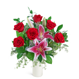 Red roses and pink lilies arranged in a white vase