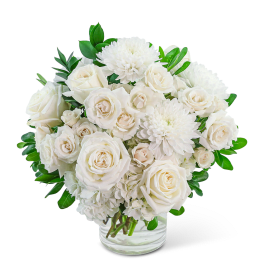 White roses and chrysanthemums in a clear glass vase