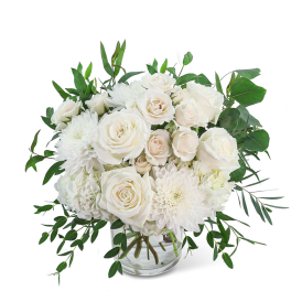 White roses and chrysanthemums in a clear glass vase