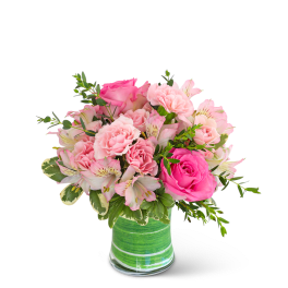 Pink roses and carnations in a green striped glass vase