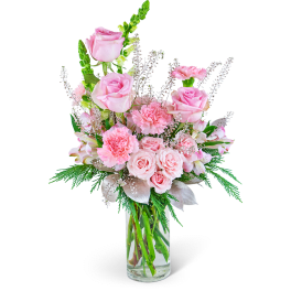 Pink roses and carnations in a clear glass vase