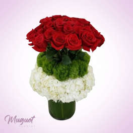 Red roses and white flowers arranged in a green vase