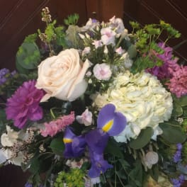 Mixed bouquet with a cream rose, purple iris, and pale hydrangea