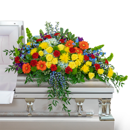 Colorful floral spray on a silver casket