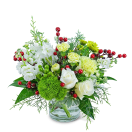 White and pale yellow floral arrangement in a clear glass vase