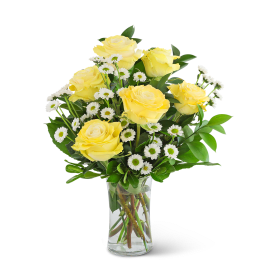 Yellow roses and white daisies in a clear glass vase