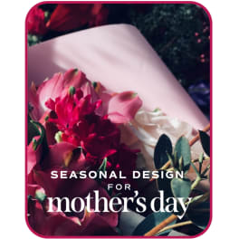 Pink and white flowers arranged with greenery, labeled for Mother's Day.