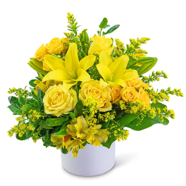 Yellow roses and lilies arranged in a white vase