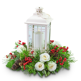 White lantern centerpiece with candles, roses, berries, and pinecones